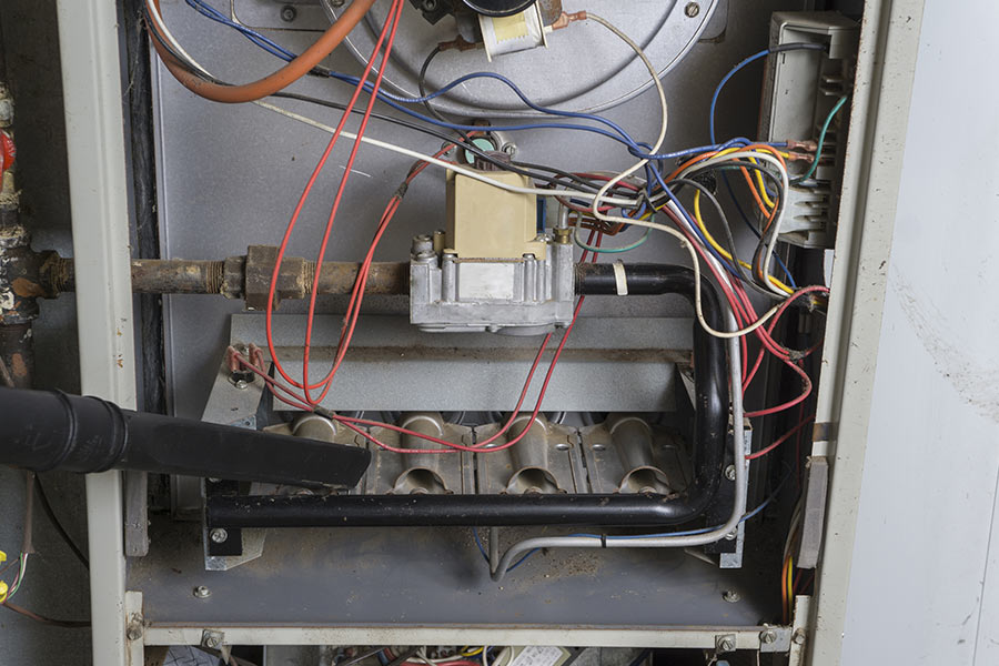 Newly installed furnace system with visible wiring and gas controls