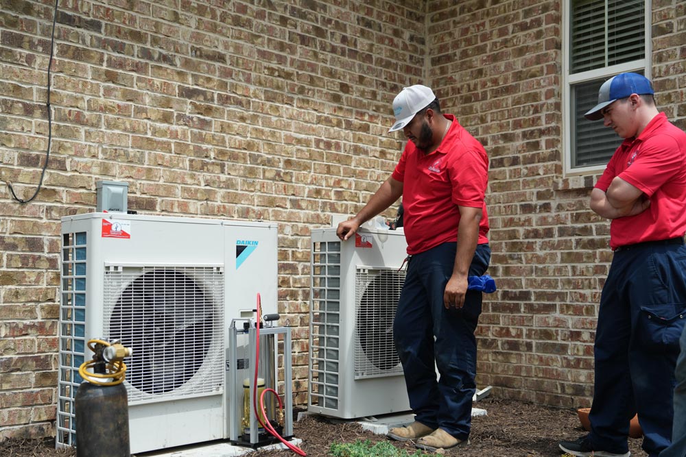 Minuteman technicians diagnosing and repairing a home heating system in Arlington